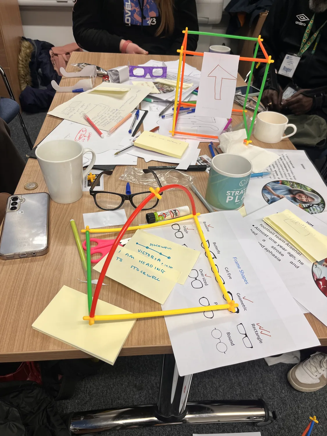 Low-fidelity smartglass prototypes built from colourful construction straws, paper arrows and handwritten notes