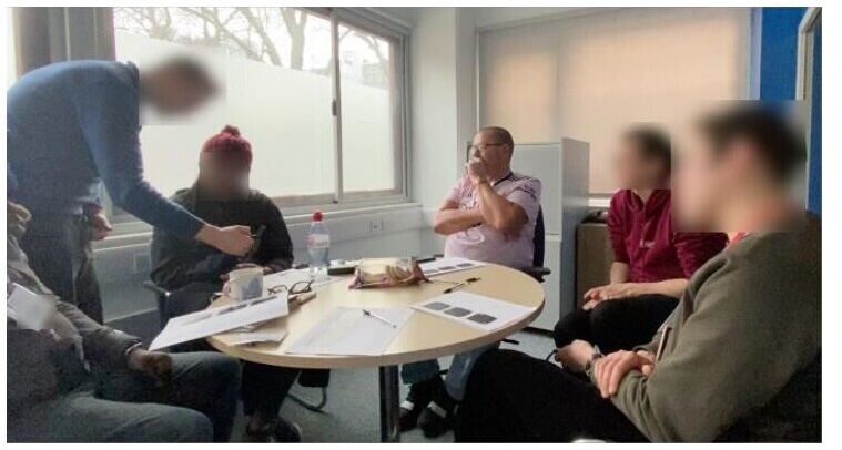People with aphasia and facilitators testing printed materials and working watch prototypes together